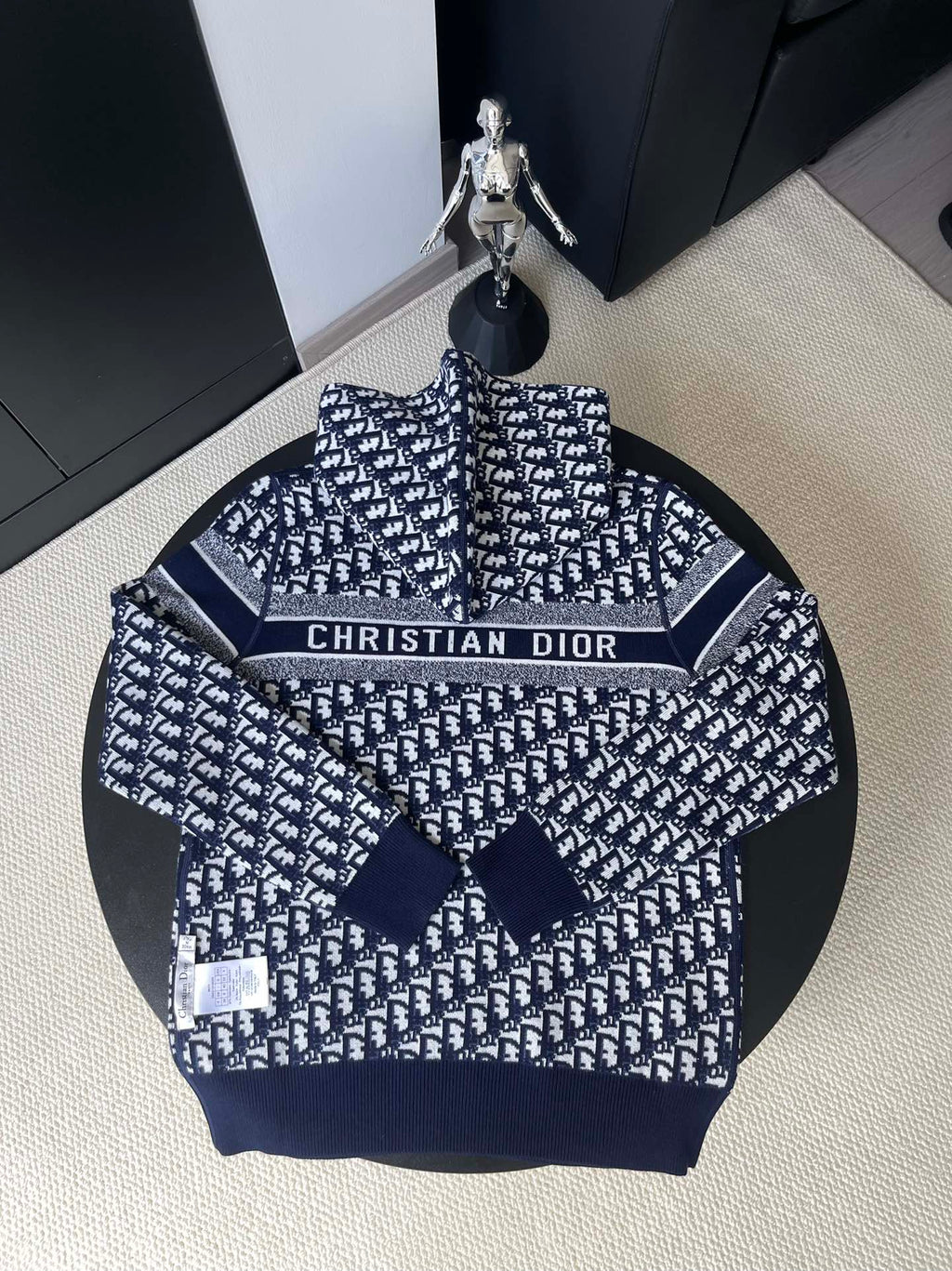 Back of Dior knit sweater with repeating pattern and logo band at chest