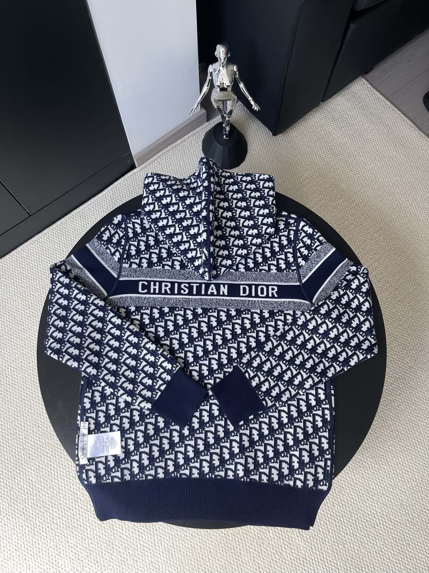 Back of Dior knit sweater with repeating pattern and logo band at chest