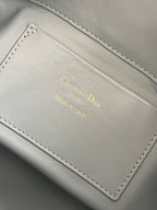 Dior light-blue leather interior label with gold 'Christian Dior' text and stitching