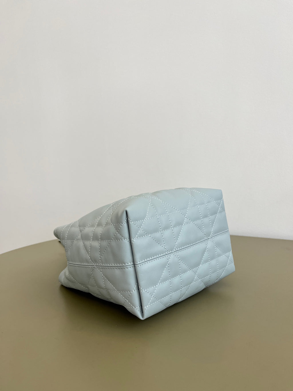 Dior light-blue quilted handbag with front panel seam and top handle strap