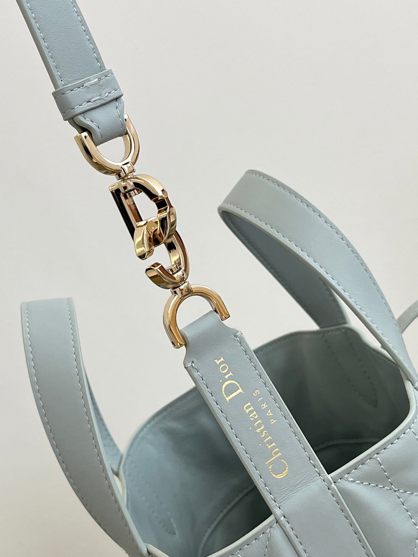 Dior light-blue shoulder strap with gold chain links and hardware clasp