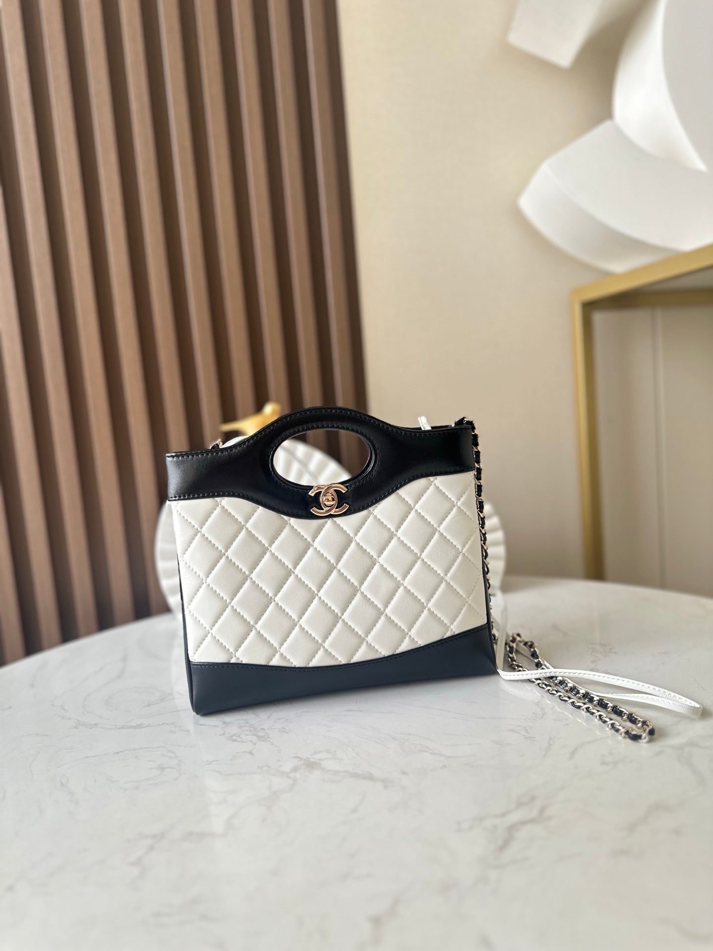 Chanel quilted mini bag with black handle, white body, gold CC logo