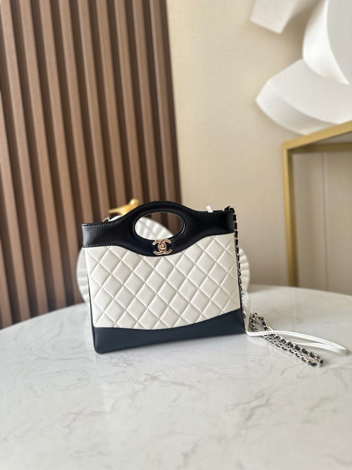 Chanel quilted mini bag with black handle, white body, gold CC logo