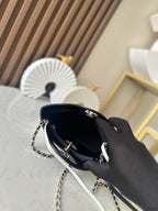 Chanel quilted mini bag open, showing black interior and gold-toned hardware