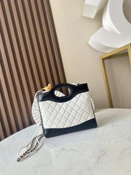 Chanel quilted mini bag with chain strap, black top handle and white diamond panel