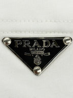 Prada metal triangle logo badge with PRADA MILANO detail on white T-shirt