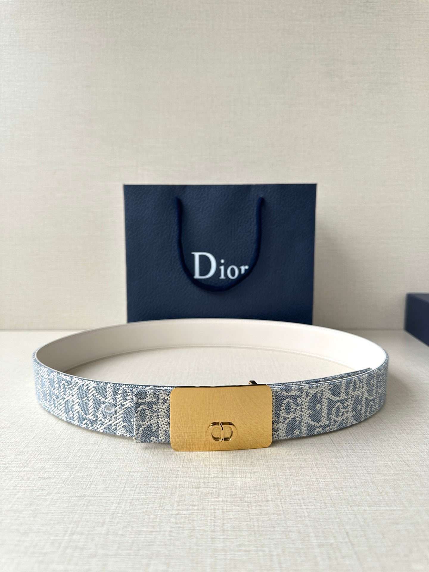 Dior belt with light blue monogram strap and gold-tone buckle