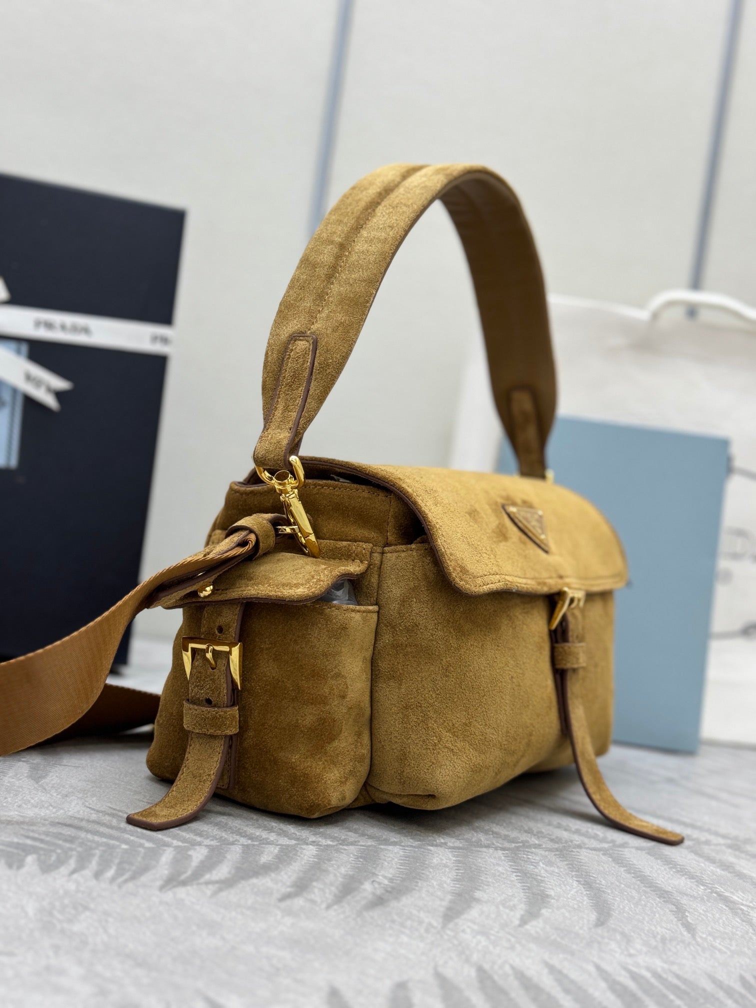 Prada suede mini shoulder bag with flap and side pockets, adjustable shoulder strap
