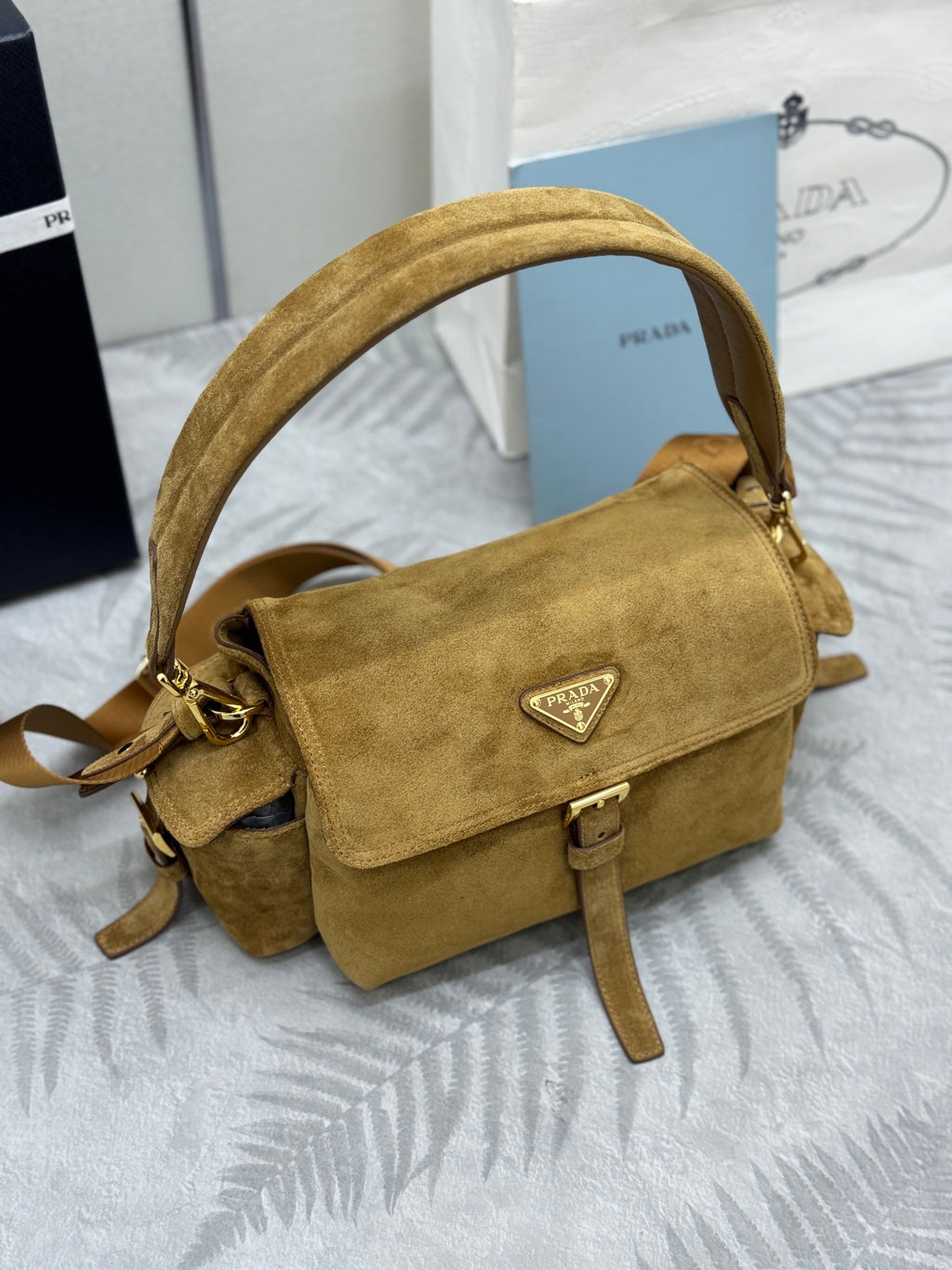 Prada suede crossbody bag with front flap, triangular logo plaque, top handle