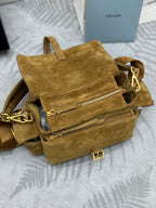Prada suede mini bag open, showing zip pocket and interior lining