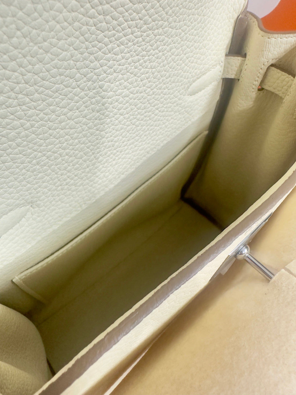 Cream leather handbag interior lining with smooth side panel and stitched seams