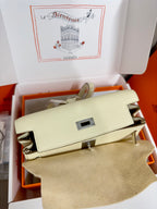 Cream leather handbag with front flap and silver clasp, flap folded back detail