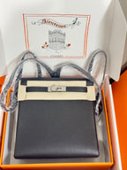 Hermes handbag in dark textured leather, front flap with belt clasp and strap.