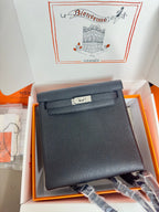 Hermes handbag in dark textured leather, flap front with silver-tone clasp hardware.