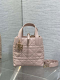 Quilted pale pink handbag with top handles and removable crossbody strap