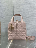 Quilted pale pink handbag with top handles and removable crossbody strap