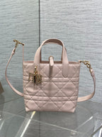 Quilted pale pink Dior handbag with top handles and side crossbody strap