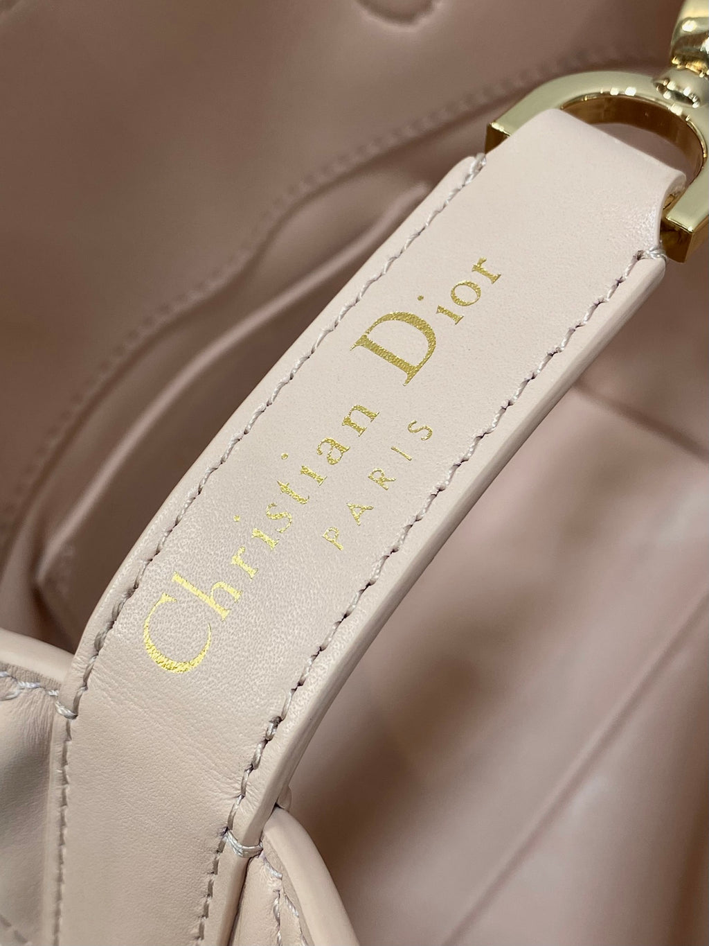Interior leather patch with Dior logo on pale pink handbag
