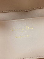 Leather stamp with Christian Dior Paris on pale pink handbag lining