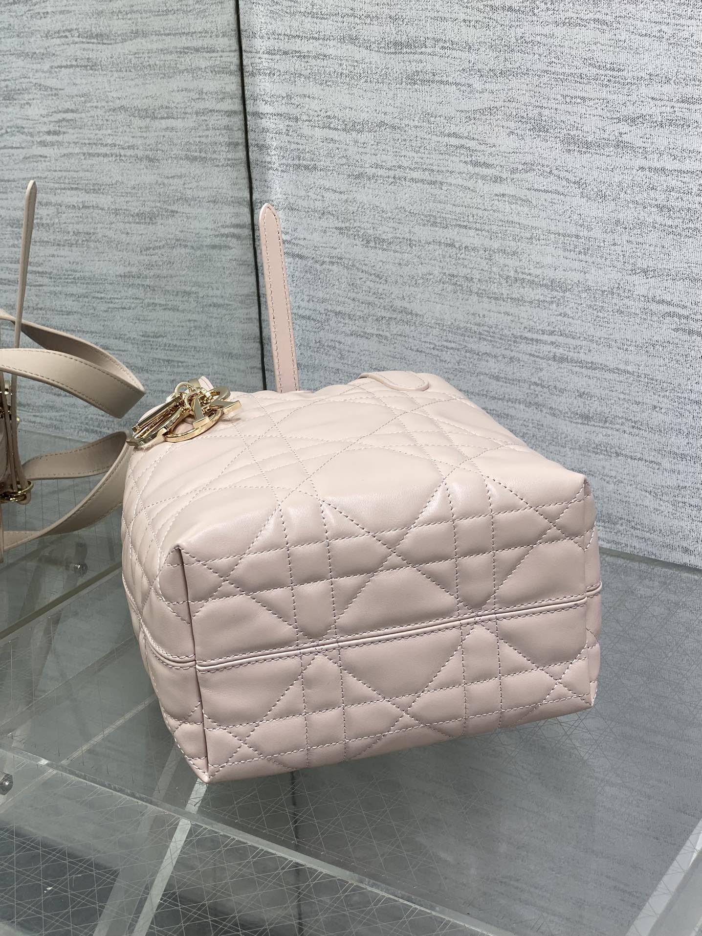 Quilted pale pink mini handbag with top handle and gold hardware