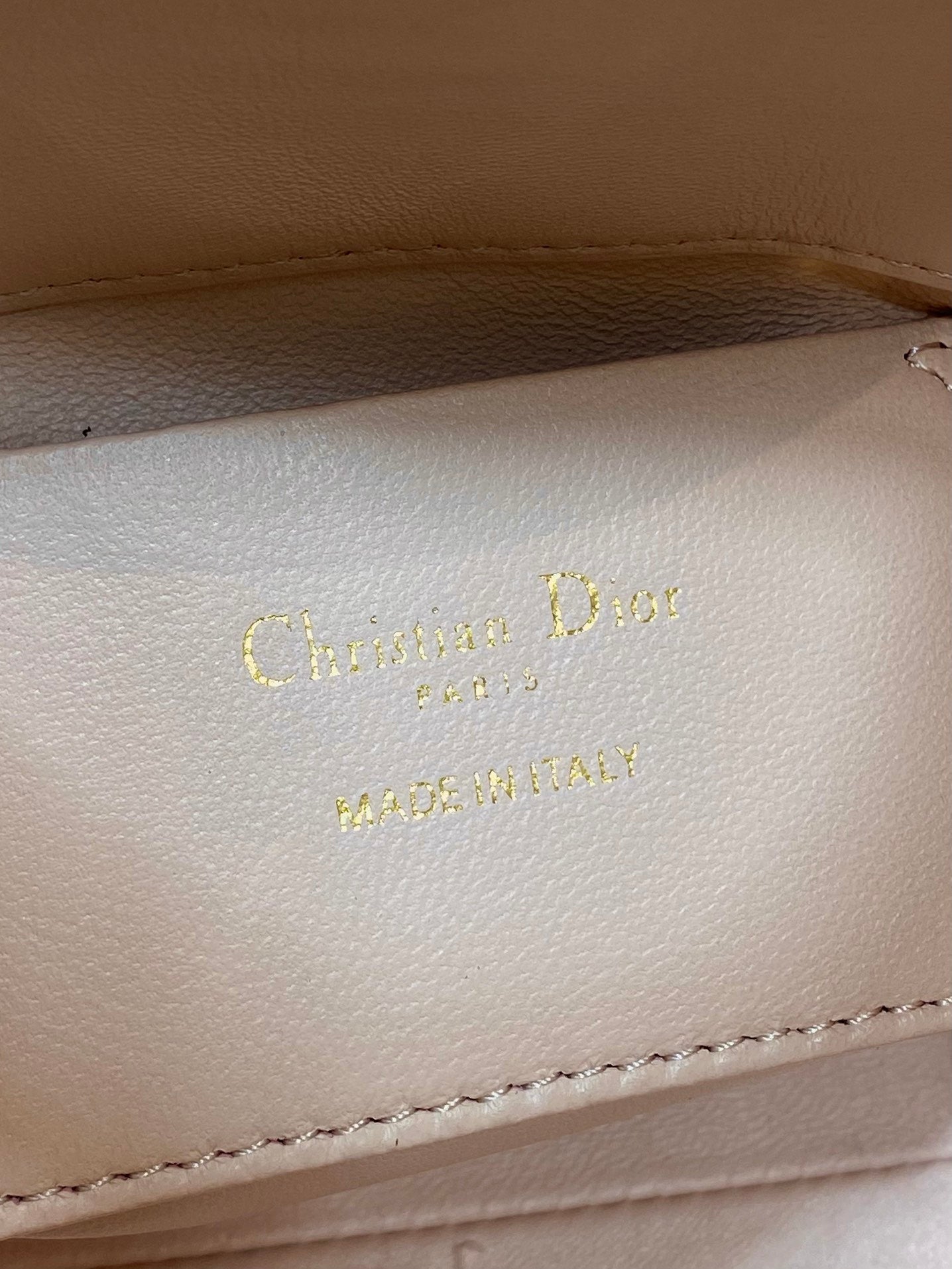 Christian Dior embossed leather label: “Christian Dior” and “MADE IN ITALY”