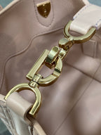 Dior bag clasp and hooks in gold-tone hardware with light pink leather trim