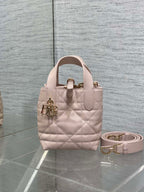 Dior quilted mini handbag in light pink with top handles and gold-tone hardware