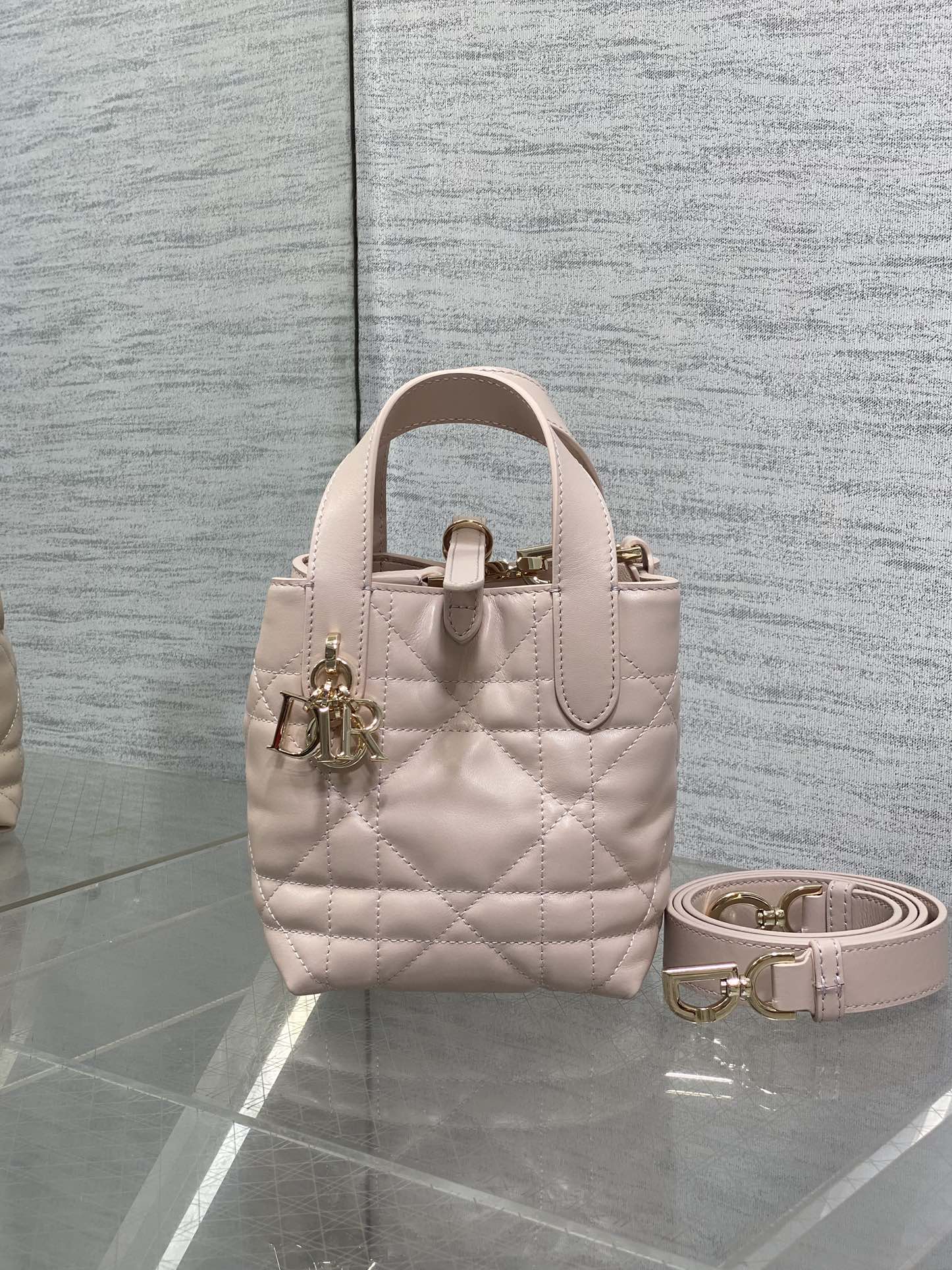 Dior quilted mini handbag in light pink with top handles and gold-tone hardware