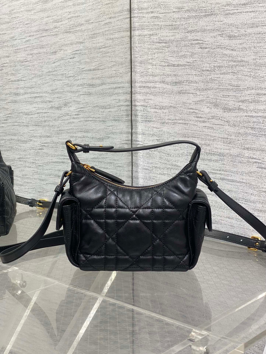 Quilted leather shoulder bag in black with gold-tone hardware and adjustable crossbody strap