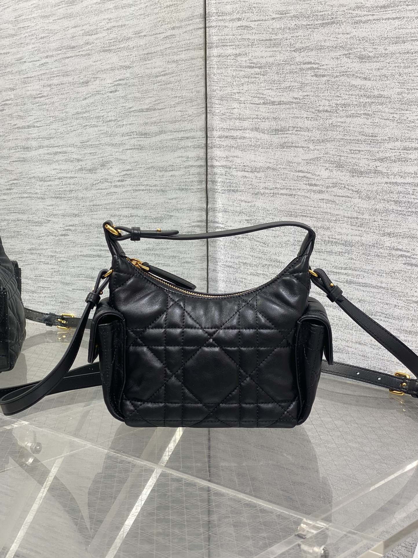 Quilted leather shoulder bag in black with gold-tone hardware and adjustable crossbody strap