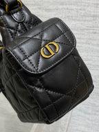Quilted black leather flap bag with gold Dior-style logo at the front