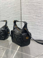 Black quilted shoulder bag with Dior emblem on front and long crossbody strap