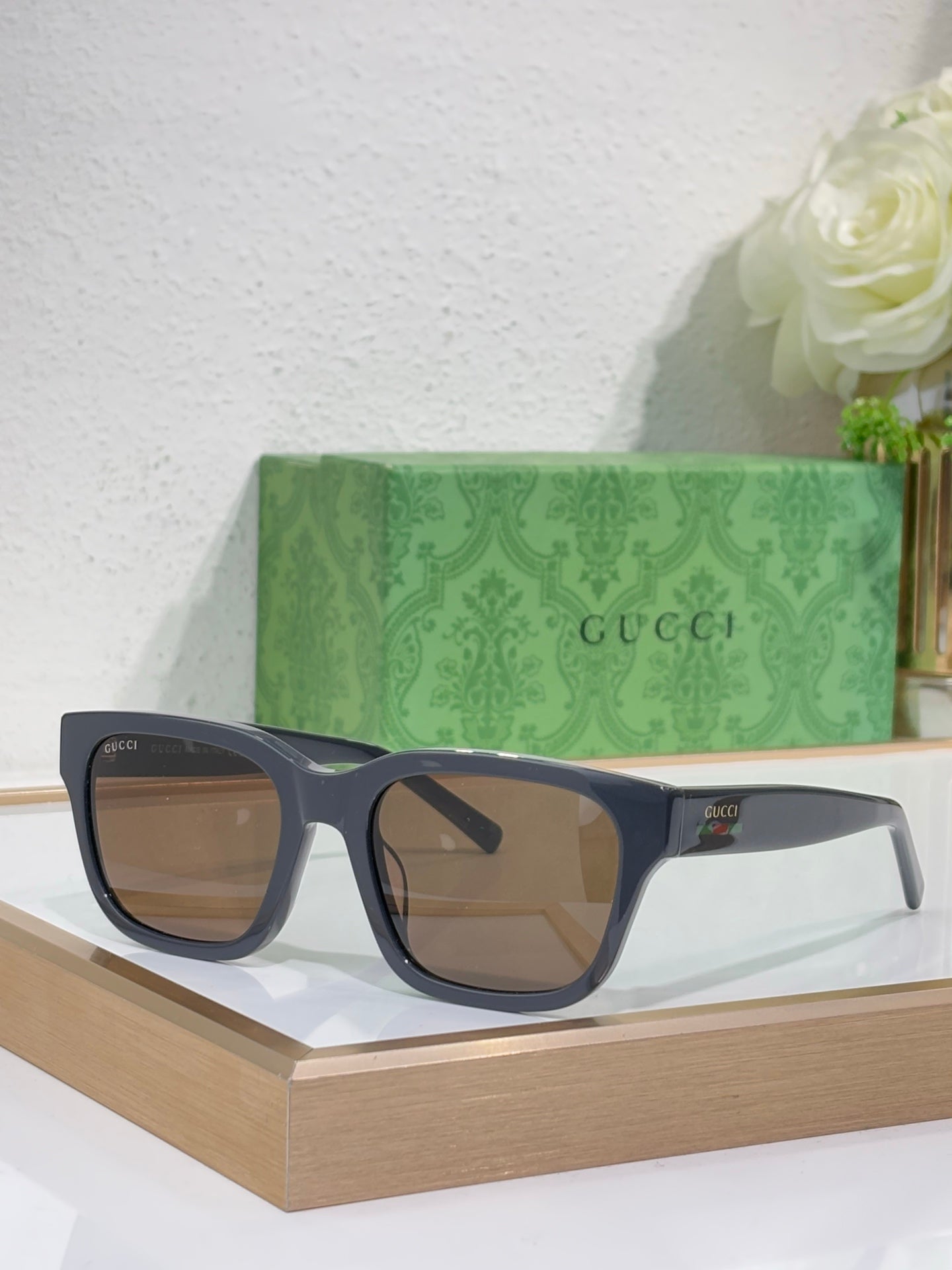 Gucci sunglasses with dark blue acetate frames and brown-tinted square lenses