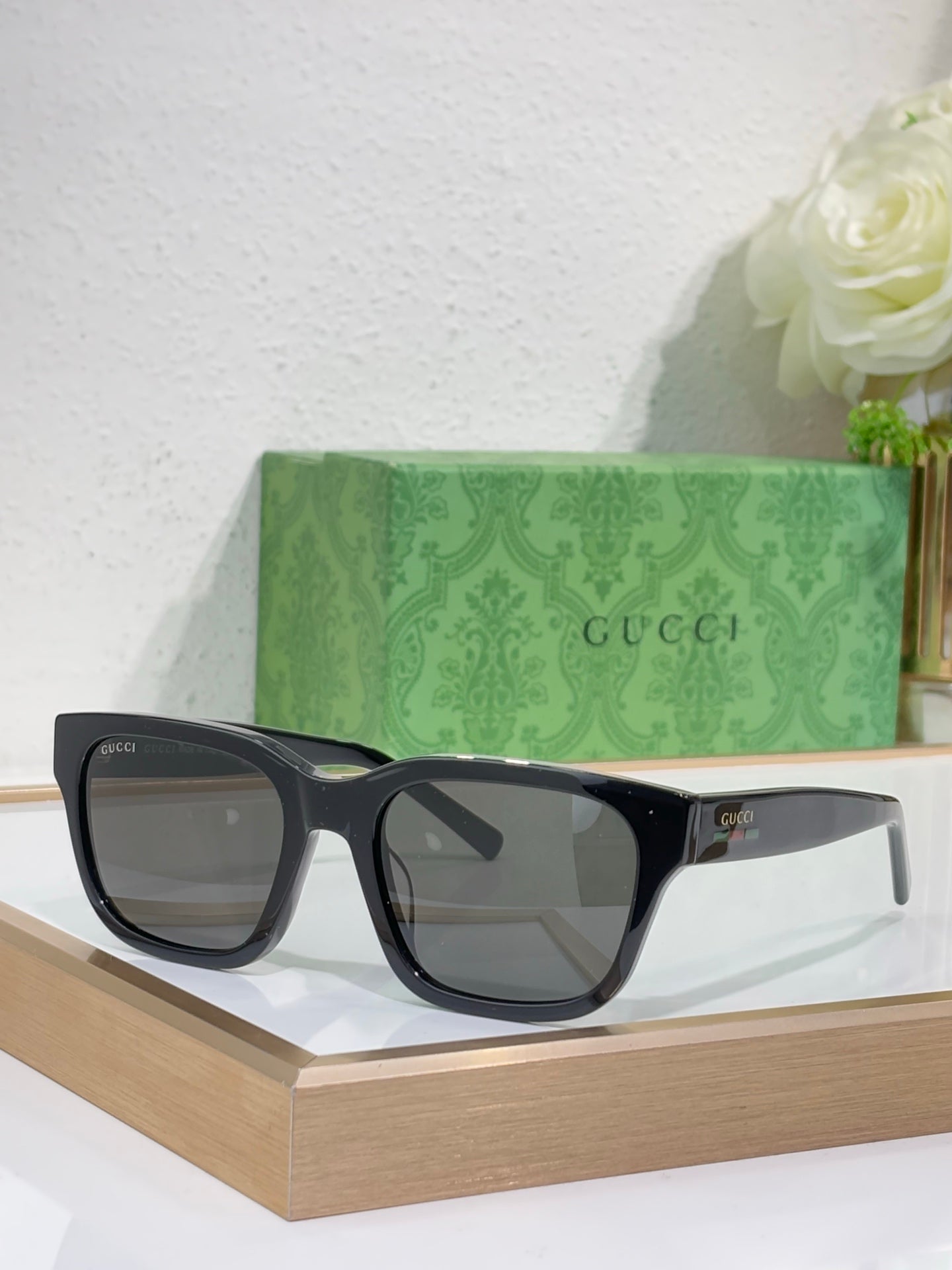 Gucci sunglasses with dark blue frames and gray-tinted square lenses