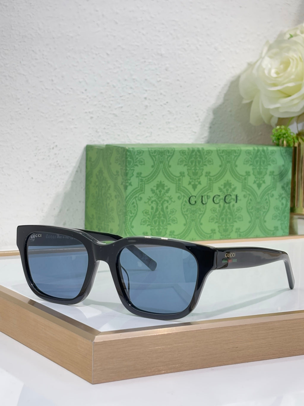 Gucci sunglasses with dark blue frames and blue-tinted square lenses
