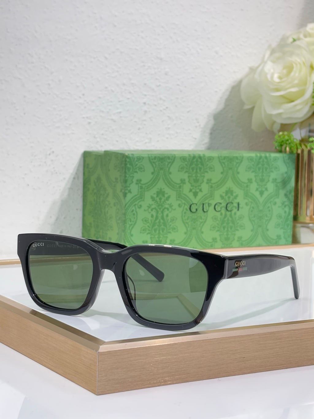 Gucci sunglasses with dark blue frames and dark green-tinted square lenses