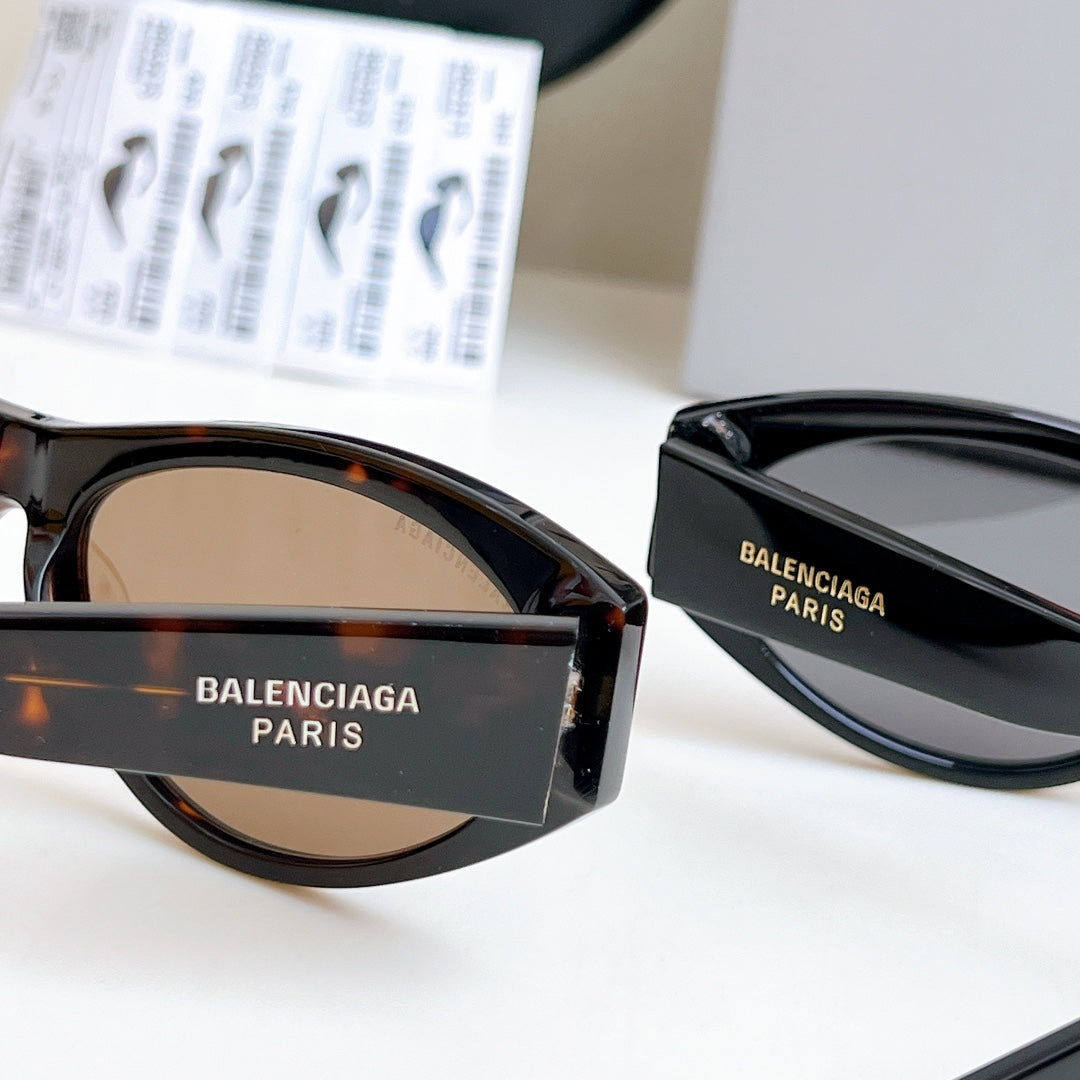 Balenciaga cat-eye sunglasses with brown lenses and glossy black frame