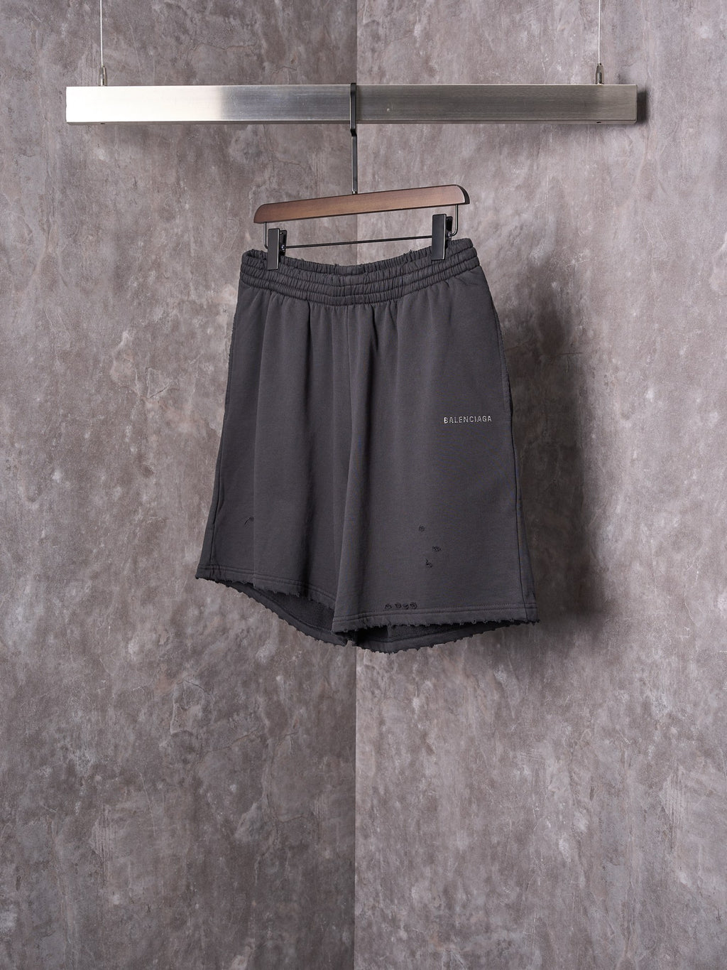 Black shorts with elastic waist, drawstring, and small side logo detail.