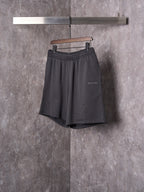 Black shorts with elastic waist, drawstring, and small side logo detail.