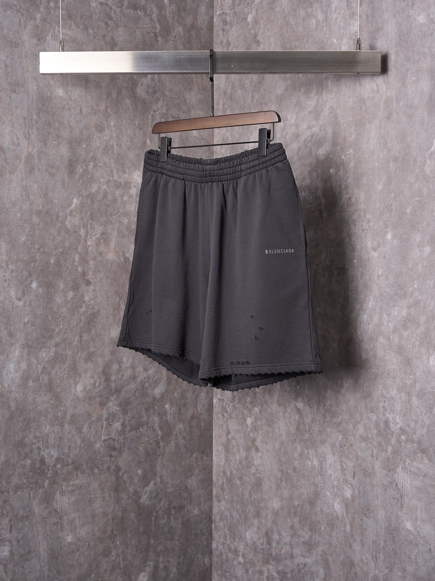 Black shorts with elastic waist, drawstring, and small side logo detail.