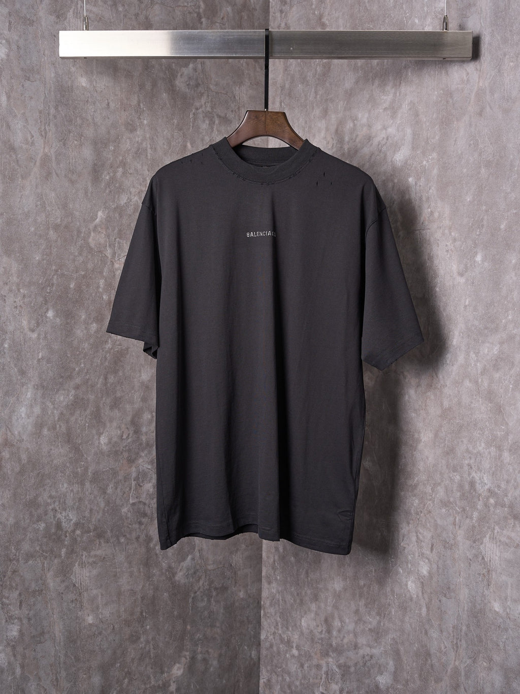 Balenciaga black short-sleeve T-shirt on hanger with small chest logo