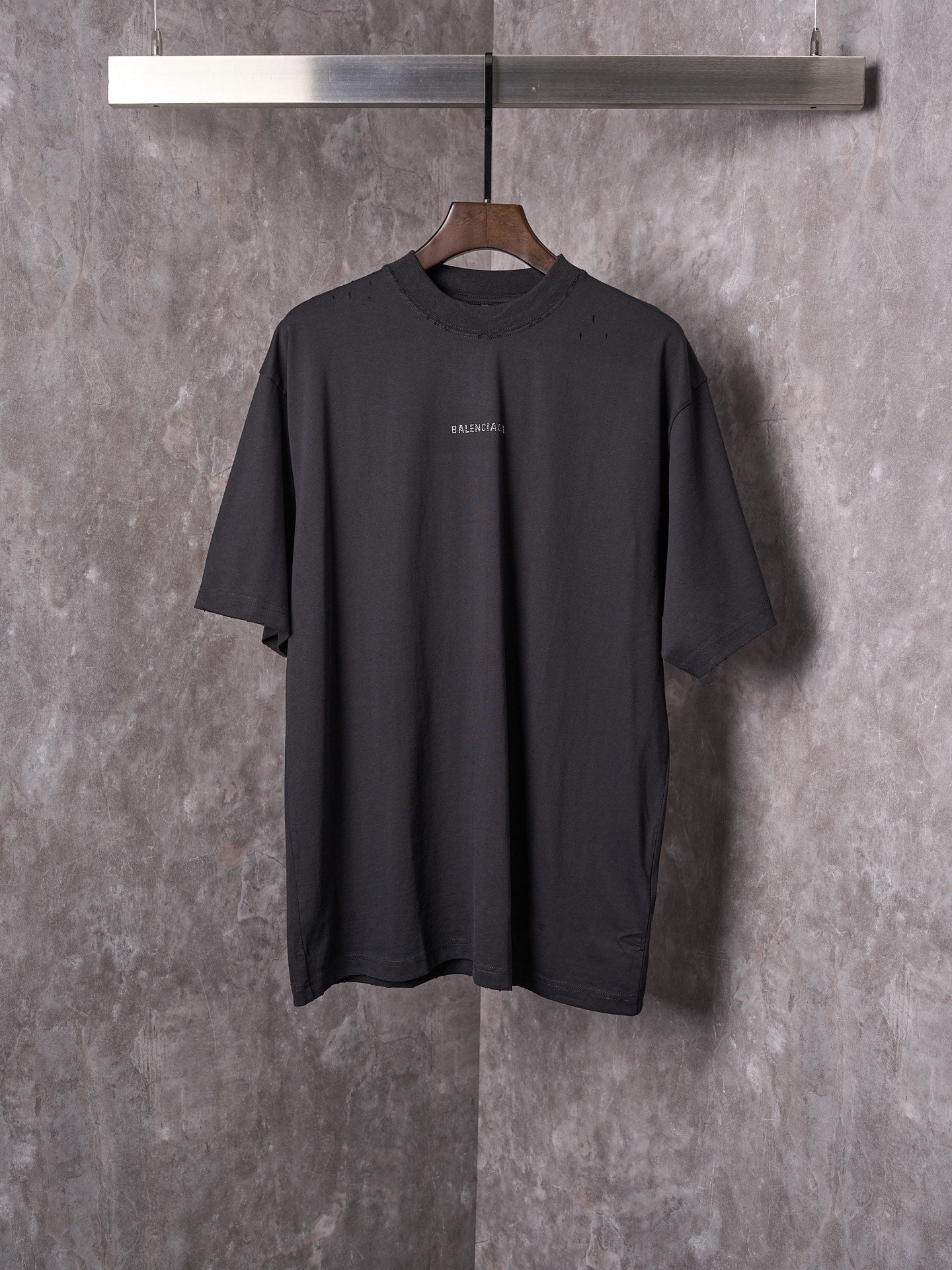 Balenciaga black short-sleeve T-shirt on hanger with small chest logo