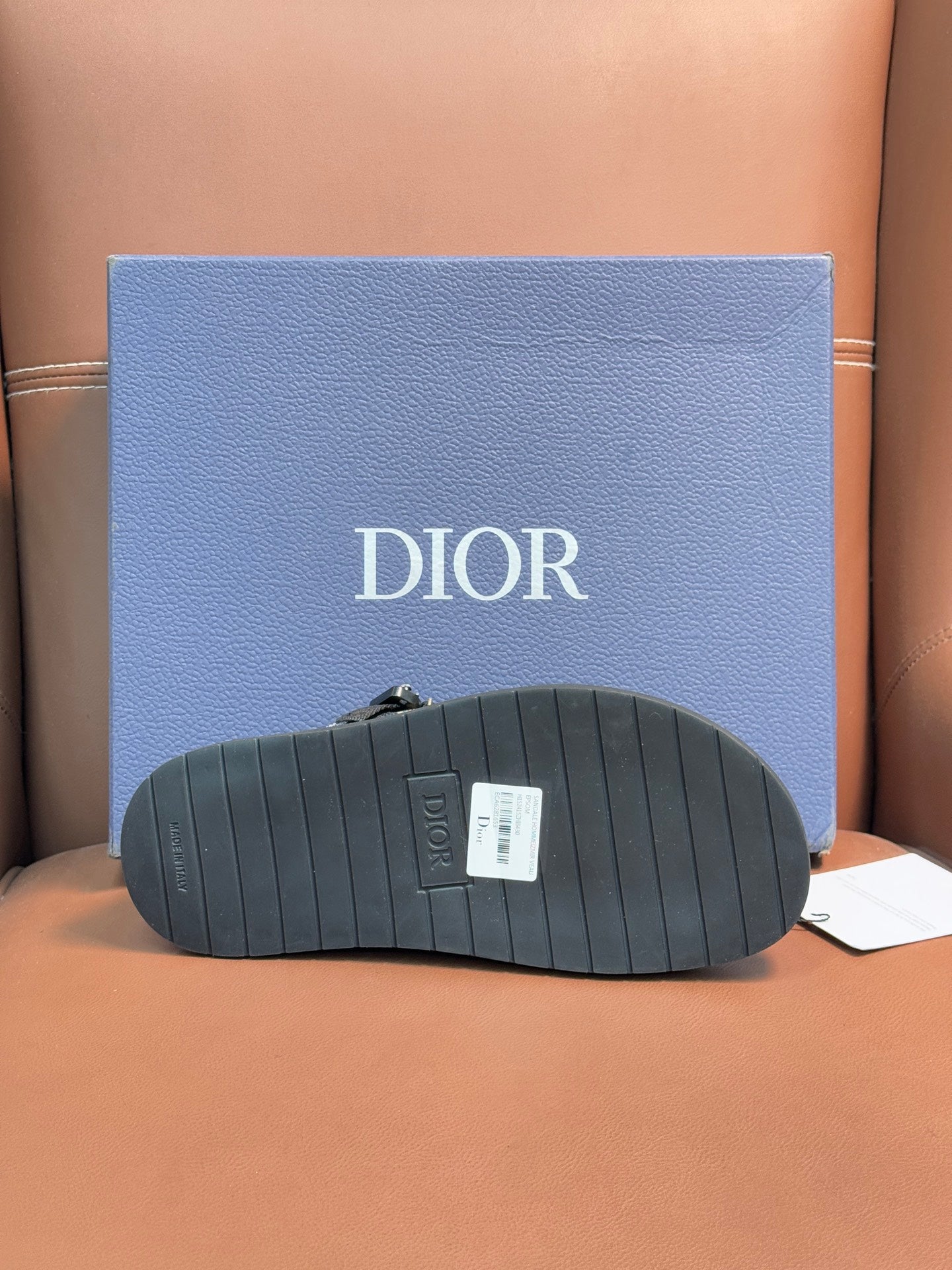Dior sandals outsole view, ribbed dark sole with Dior tag