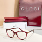 Gucci glasses with red round frames and clear lenses