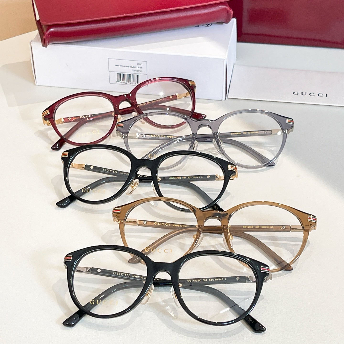 Gucci glasses set with red, black, gold, and gray-blue round frames