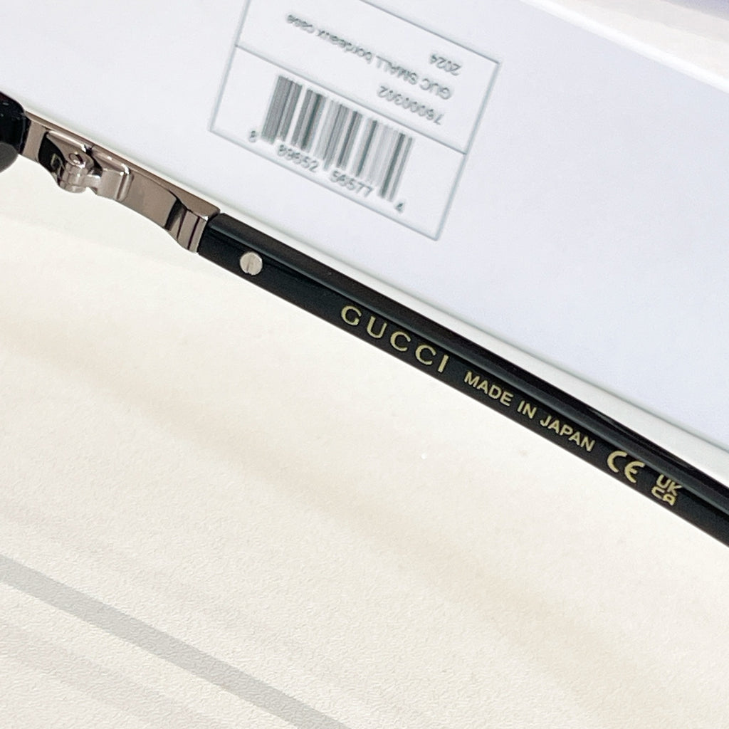 Gucci glasses temple close-up with printed brand text and label