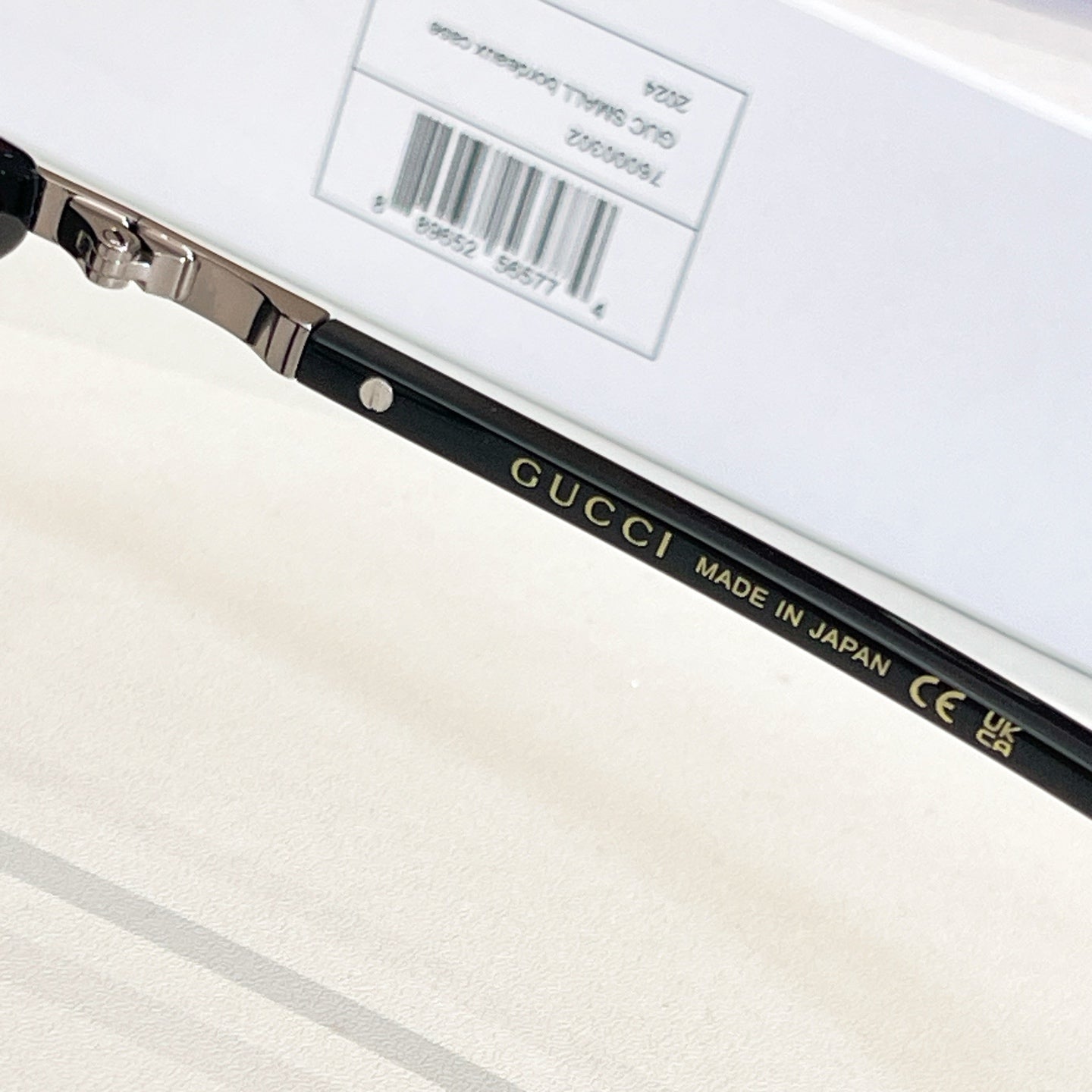 Gucci glasses temple close-up with printed brand text and label