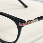 Gucci glasses, black frame close-up with logo detail on temple