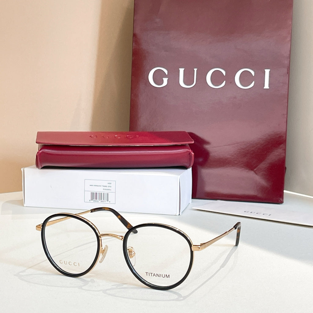 Gucci round eyeglasses, black frame with gold accents and clear lenses