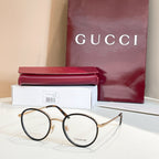 Gucci round eyeglasses, black frame with gold accents and clear lenses